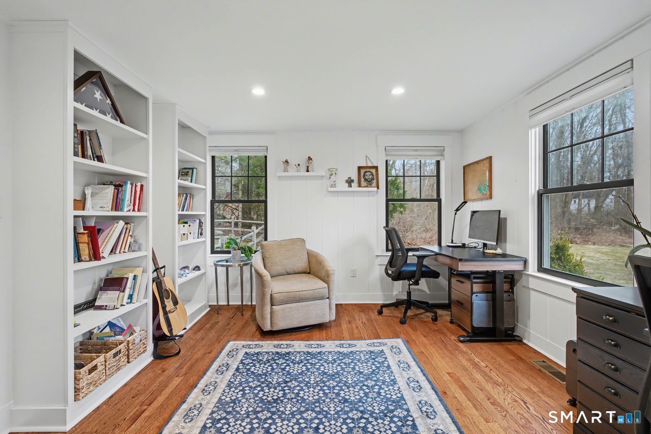 61 Bishop Lane Madison, CT 06443 - Photo 20 of 41 a living room with furniture and a book shelf