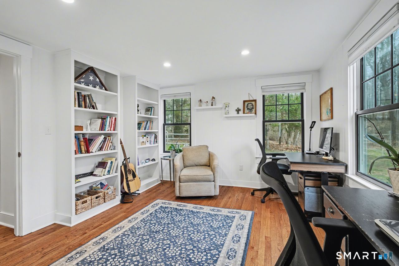 61 Bishop Lane Madison, CT 06443 - Photo 22 of 41 a living room with furniture and a book shelf
