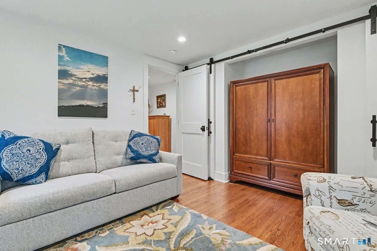 61 Bishop Lane Madison, CT 06443 - Photo 25 of 41 a living room with furniture and a gate