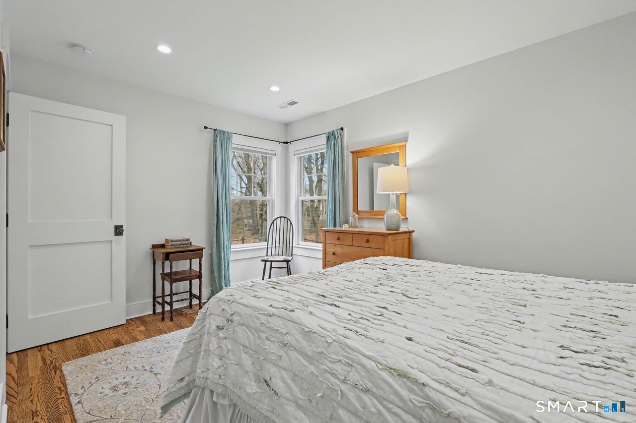 61 Bishop Lane Madison, CT 06443 - Photo 28 of 41 a bedroom with a bed and wooden floor