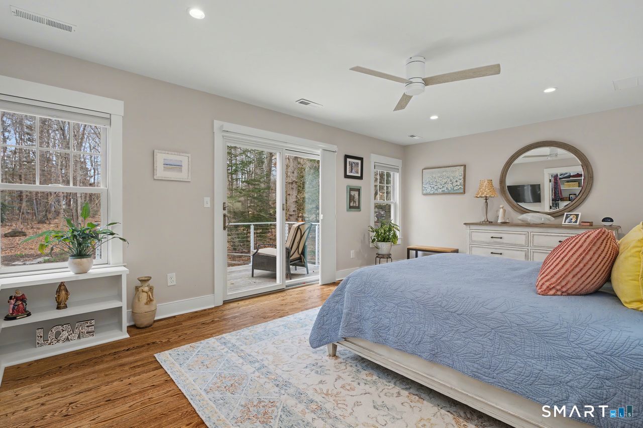 61 Bishop Lane Madison, CT 06443 - Photo 29 of 41 a bedroom with a large bed and a large window