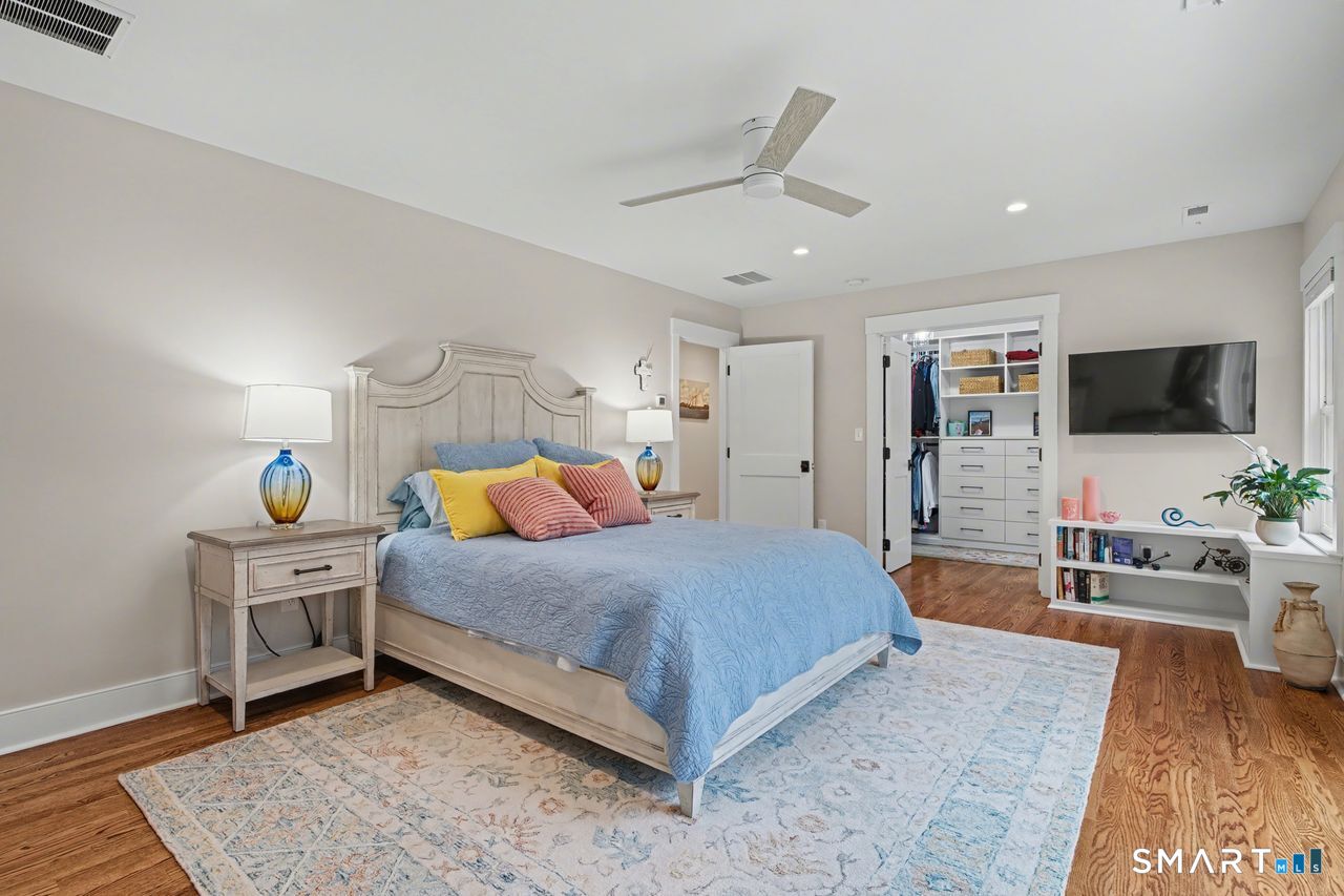 61 Bishop Lane Madison, CT 06443 - Photo 31 of 41 a spacious bedroom with a bed and a flat screen television