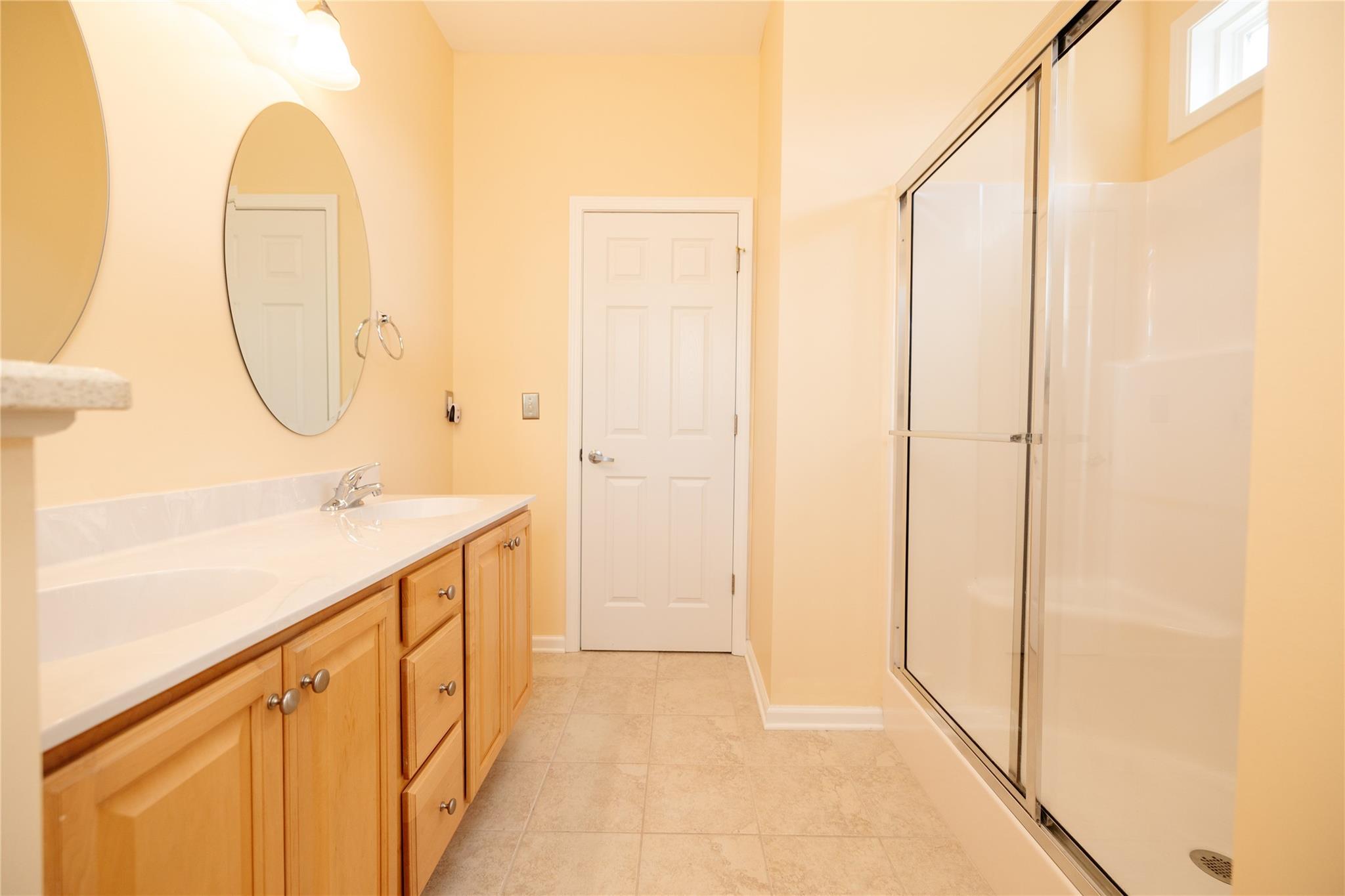 330 West Swift Creek Road Fletcher, NC 28732 - Photo 14 of 29 a bathroom with a double vanity sink and a mirror