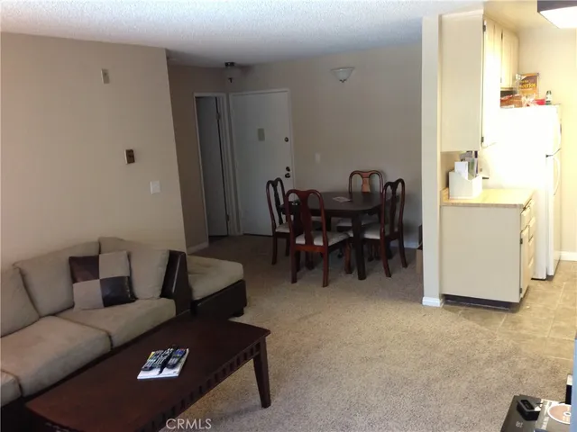 a living room with furniture and a dining table