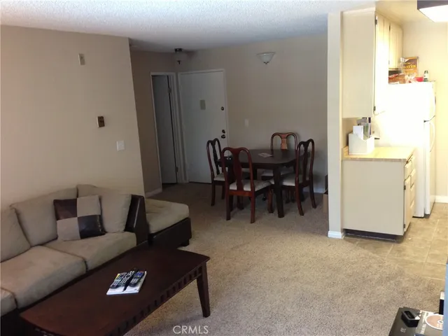 a living room with furniture and a dining table
