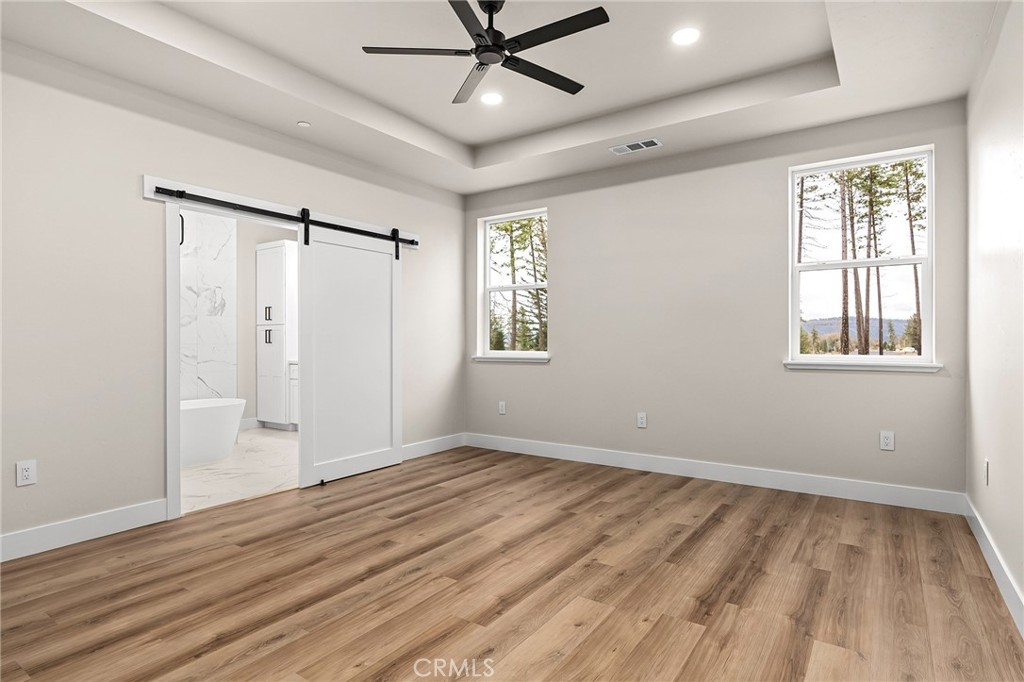 707 Madrone Way Paradise, CA 95969 - Photo 13 of 47 a view of an empty room with a window and wooden floor