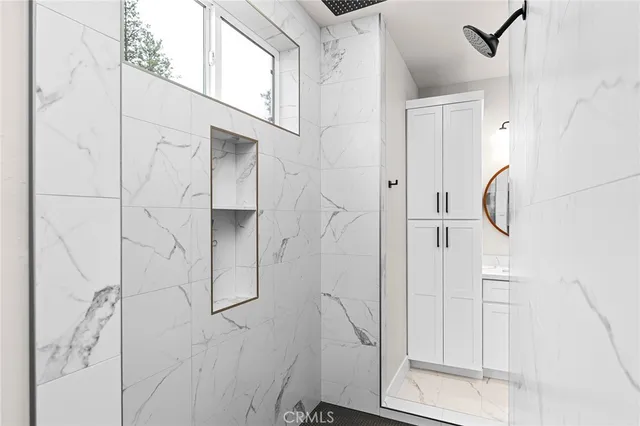 a bathroom with a glass shower door and a bathroom