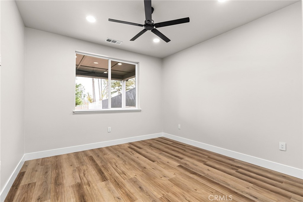 707 Madrone Way Paradise, CA 95969 - Photo 22 of 47 a view of empty room with wooden floor and fan