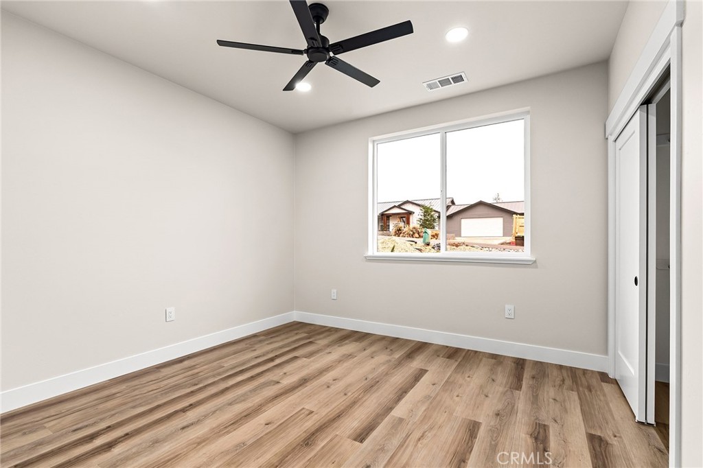 707 Madrone Way Paradise, CA 95969 - Photo 26 of 47 a view of empty room with wooden floor and fan