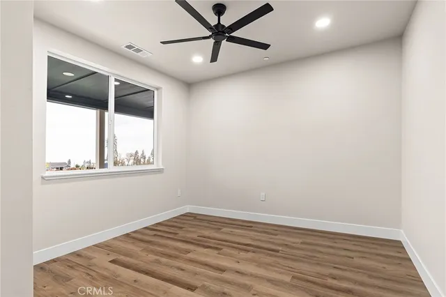 a view of empty room with wooden floor