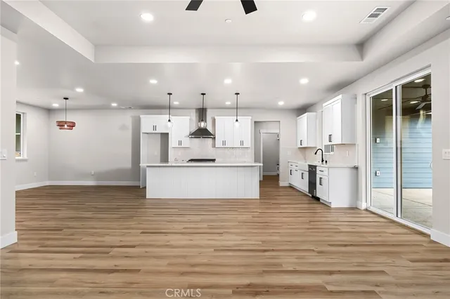 a view of kitchen with kitchen island a sink stainless steel appliances and cabinets