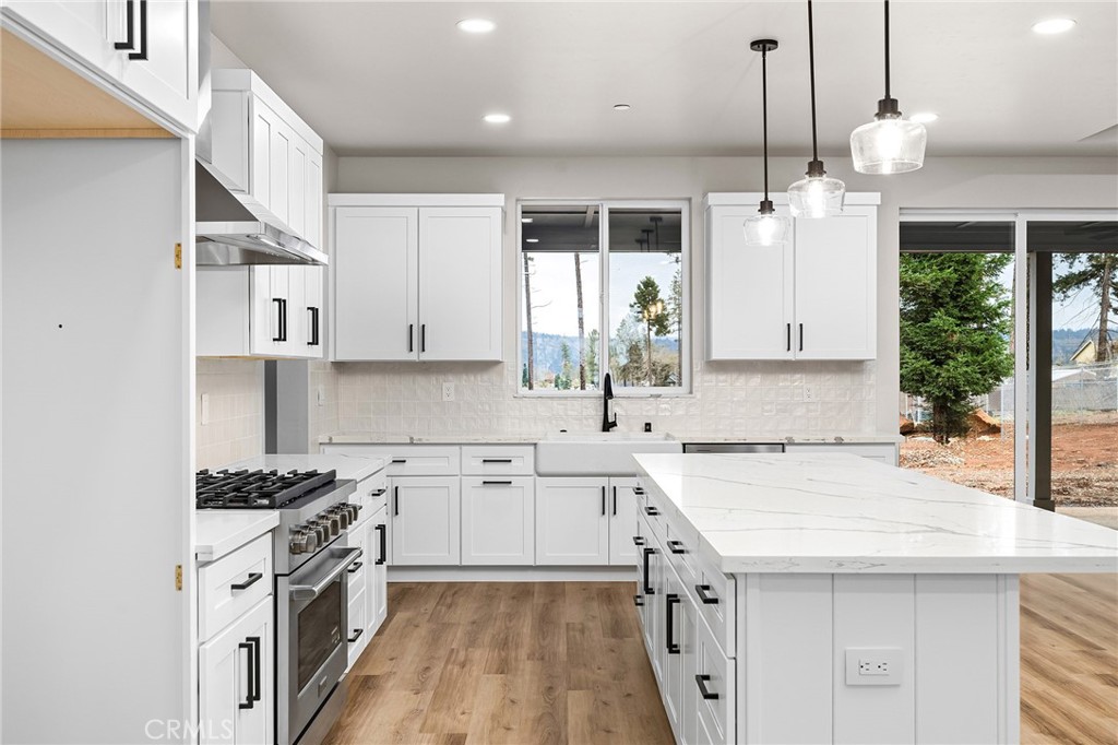 707 Madrone Way Paradise, CA 95969 - Photo 7 of 47 a kitchen with a sink stove and cabinets