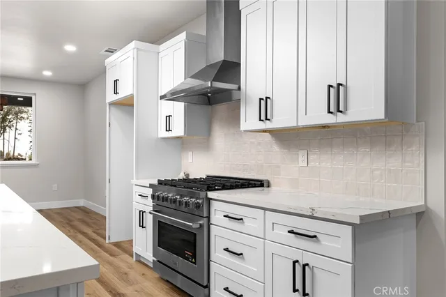 a kitchen with stainless steel appliances granite countertop a sink a stove and a microwave