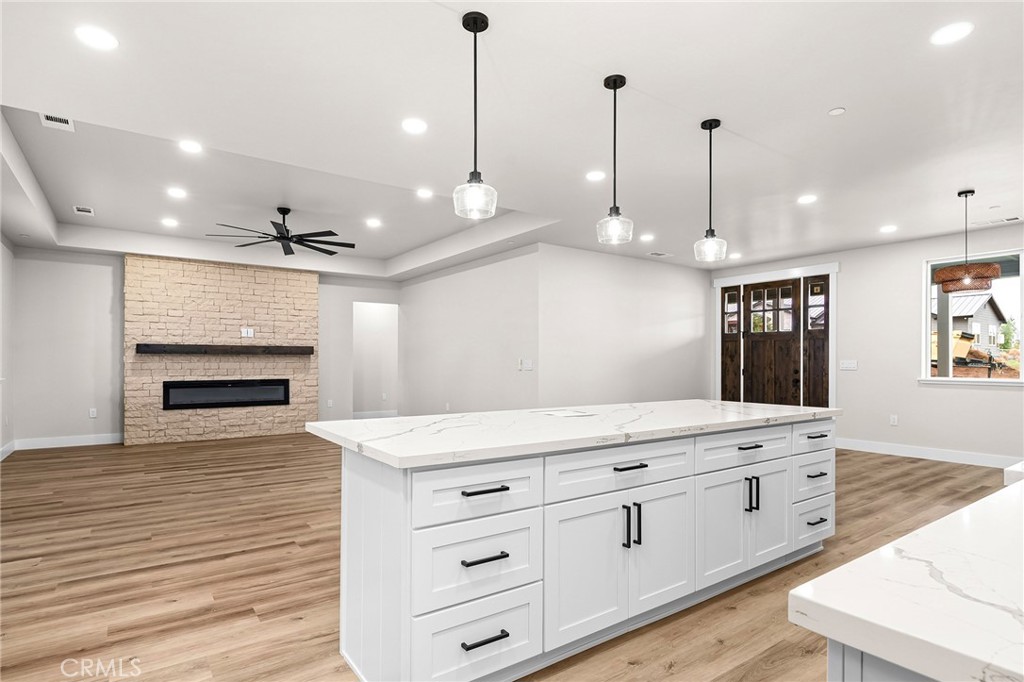 707 Madrone Way Paradise, CA 95969 - Photo 10 of 47 a view of a kitchen with kitchen island a sink stainless steel appliances and wooden floor
