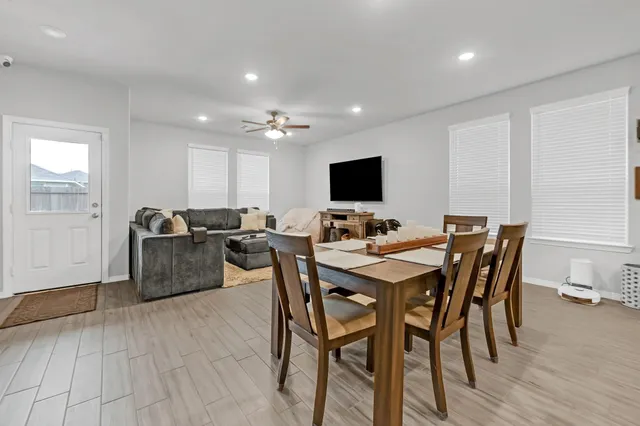 a view of a dining room with furniture and wooden floor