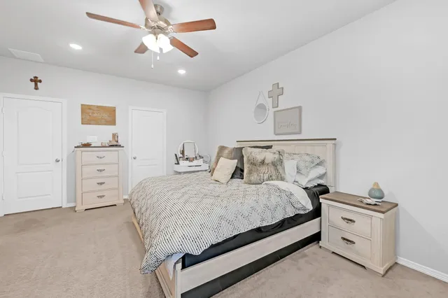 a bedroom with a bed and a chandelier