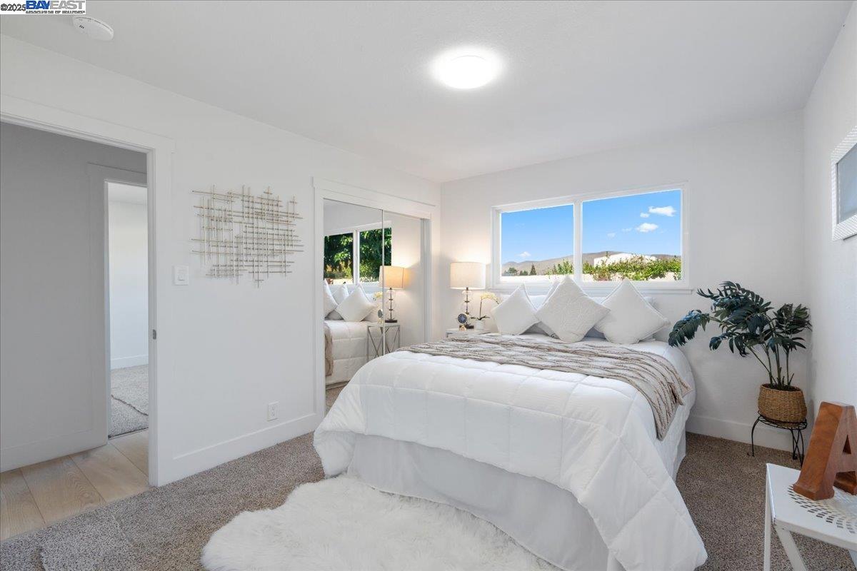 4023 Roland Drive Concord, CA 94521 - Photo 32 of 59 a bed room with a bed and a potted plant