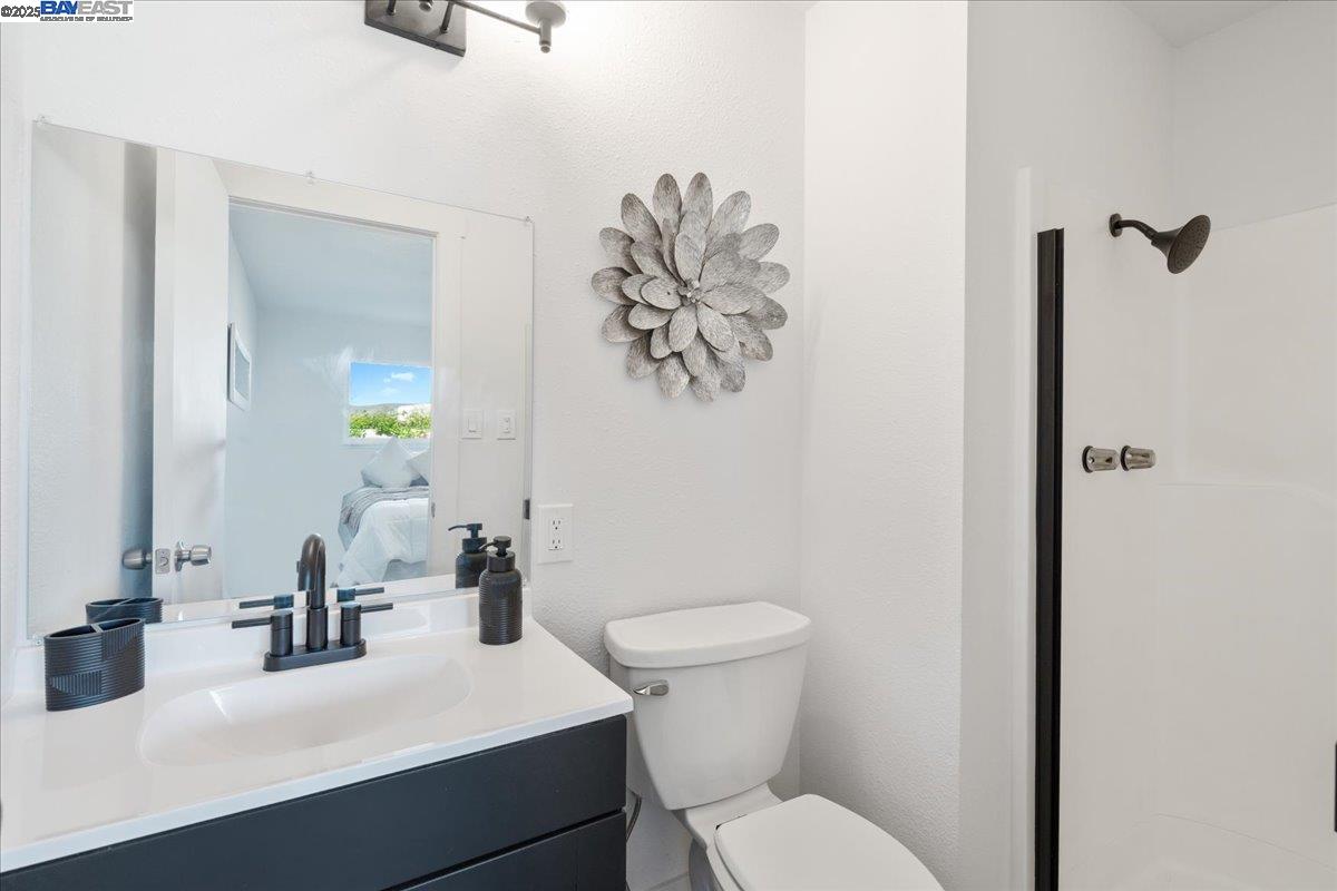 4023 Roland Drive Concord, CA 94521 - Photo 36 of 59 a bathroom with a sink mirror and toilet