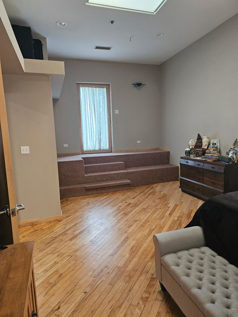 537 Custer Avenue, Unit 5 Evanston, IL 60202 - Photo 14 of 19 a room with wooden floor and furniture