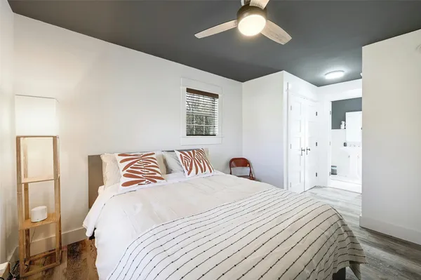 a bedroom with a large bed and a chandelier