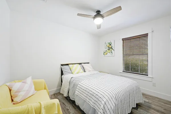 a bedroom with a bed painted wall and a large window