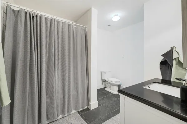 a bathroom with a toilet and a mirror