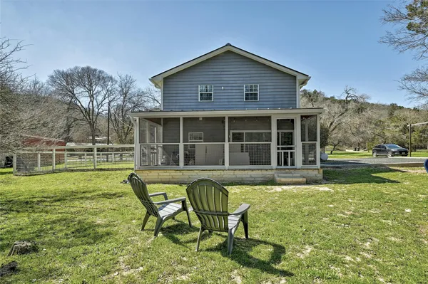 a house view with a sitting space and garden