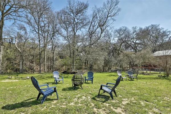 a view of a two chairs in a backyard