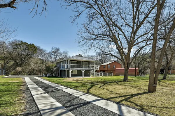 a view of house with yard and green space