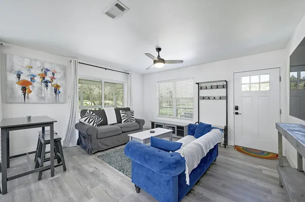 a spacious bedroom with a bed a couch and a window