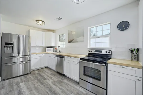 a kitchen with granite countertop a stove oven and a refrigerator