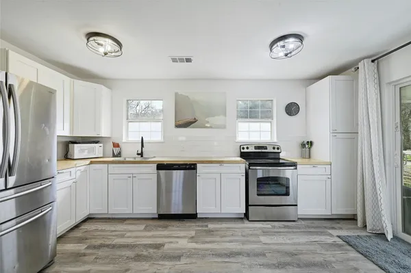 a kitchen with stainless steel appliances granite countertop a stove and a refrigerator