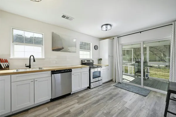 a kitchen with a sink cabinets and window