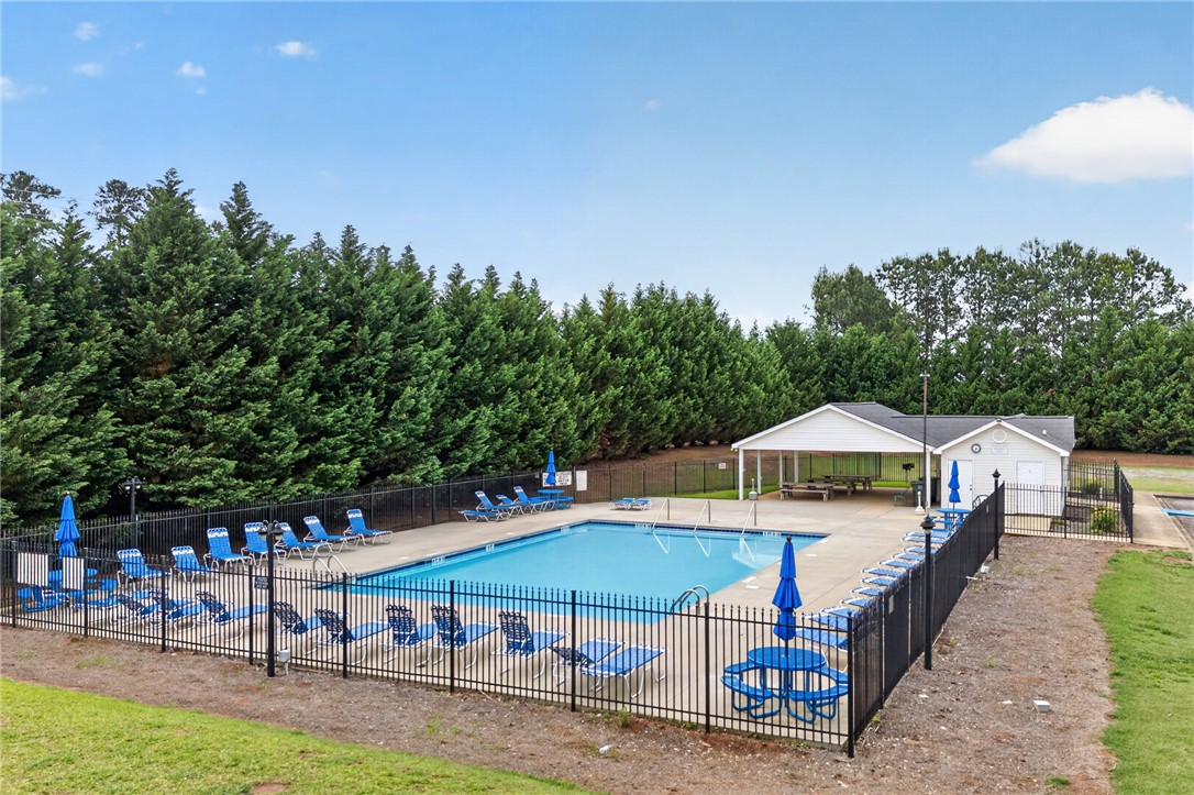 207 Hunters Lane Anderson, SC 29625 - Photo 34 of 46 A fenced-in community pool invites relaxation with ample lounge seating and a shaded picnic area.