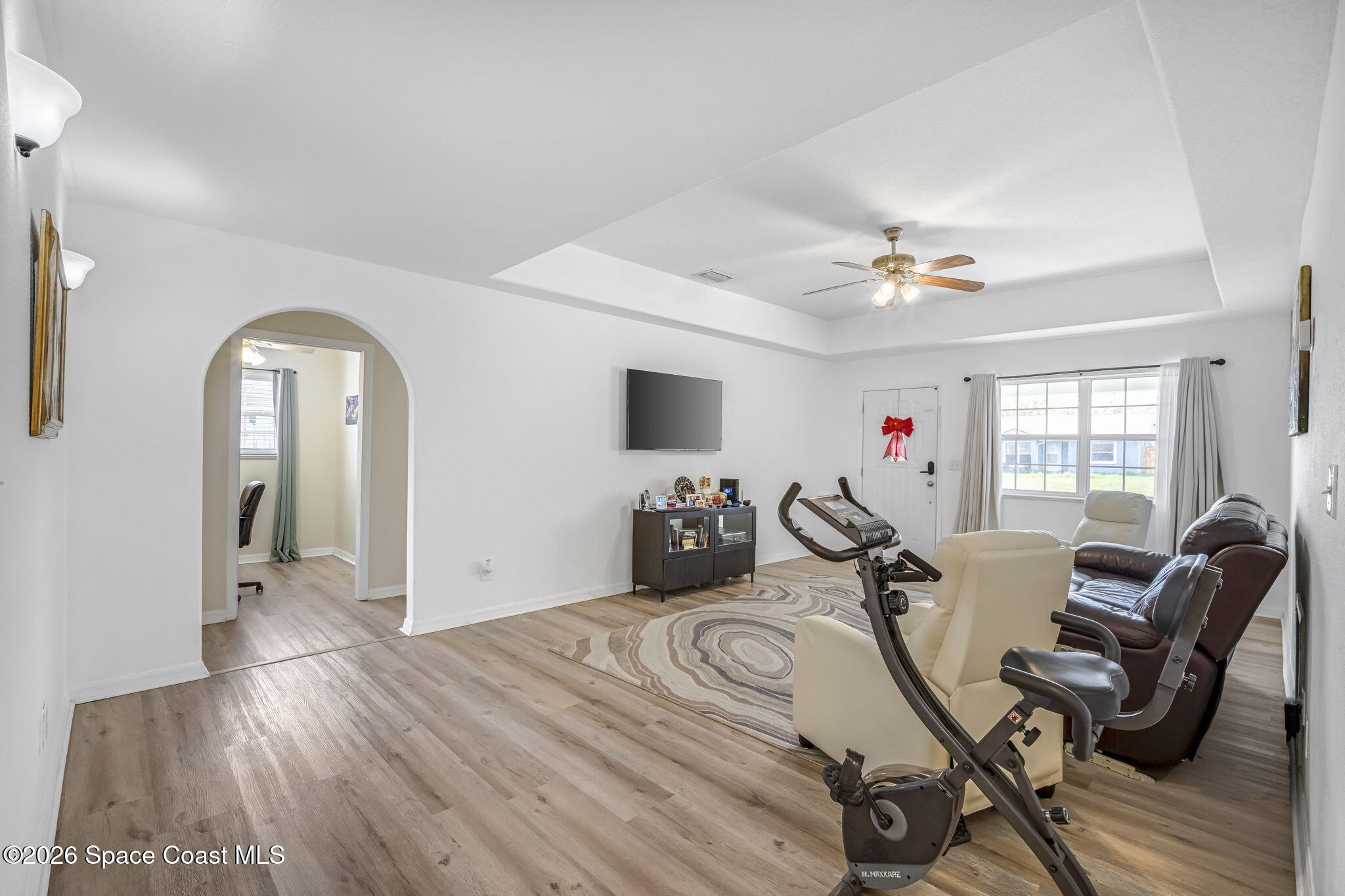 3404 Kilbee Street Mims, FL 32754 - Photo 4 of 30 a view of a livingroom with furniture a ceiling fan and wooden floor