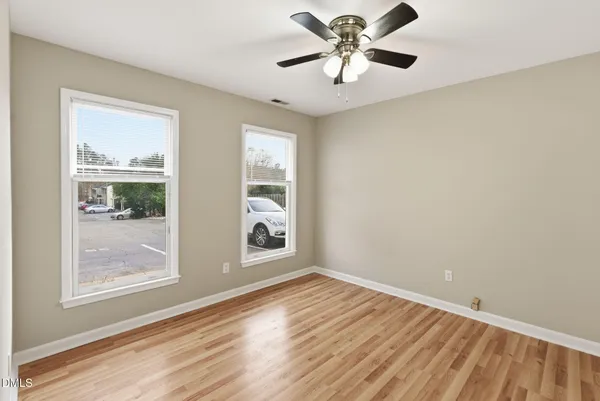 wooden floor in an empty room with a window