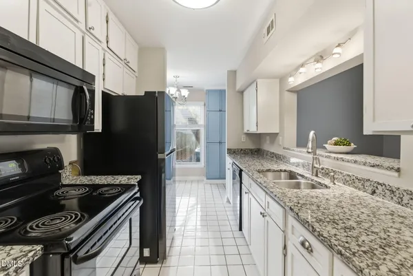 a kitchen with granite countertop stainless steel appliances and counter space
