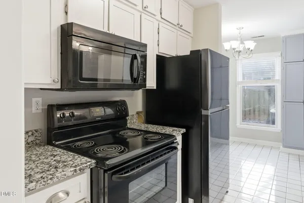 a kitchen with a stove microwave and refrigerator