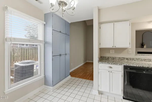 a kitchen with kitchen island granite countertop a sink cabinets and stainless steel appliances