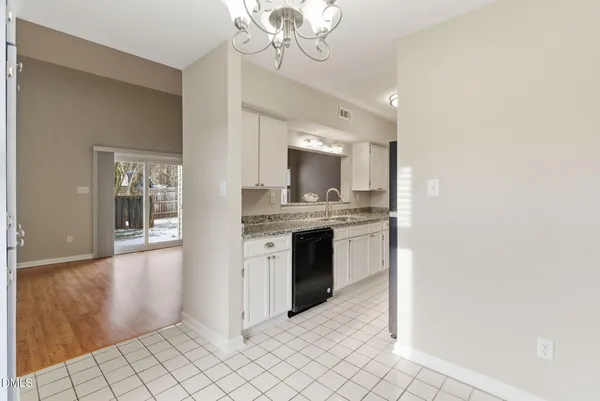 a view of empty room with wooden floor and fireplace