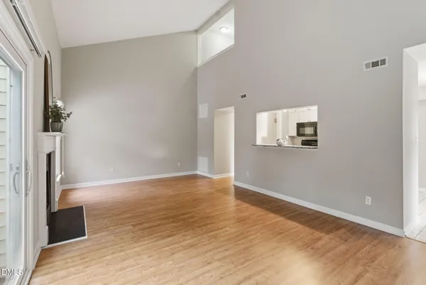 a vase of flowers besides of a table with six mirrors