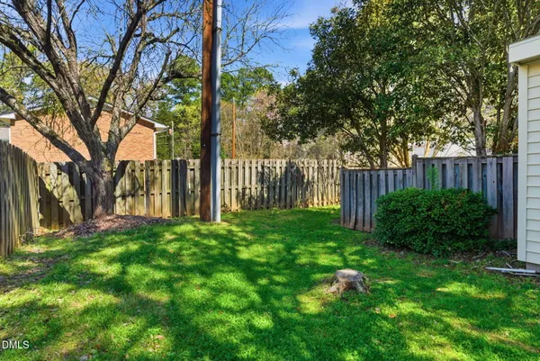 a view of a backyard with a tree