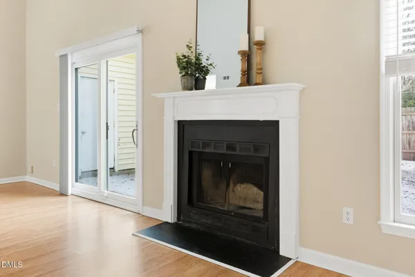 a living room with a fireplace and a potted plant