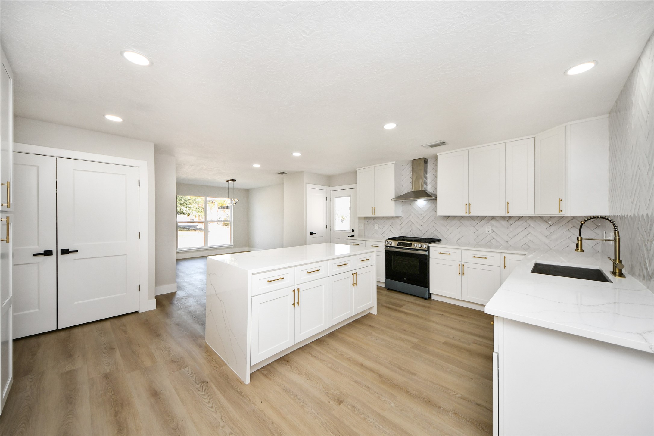10223 Dude Road Houston, TX 77064 - Photo 13 of 44 a large kitchen with stainless steel appliances granite countertop a stove and white cabinets