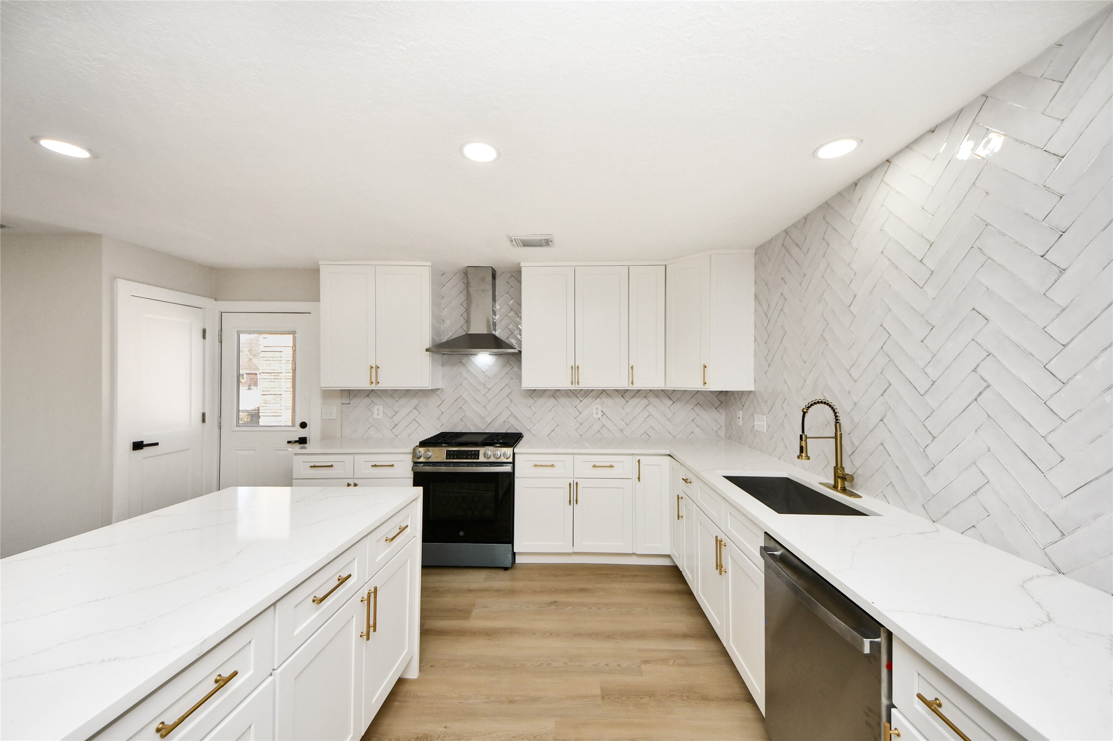 10223 Dude Road Houston, TX 77064 - Photo 14 of 44 a kitchen with stainless steel appliances a sink stove and cabinets
