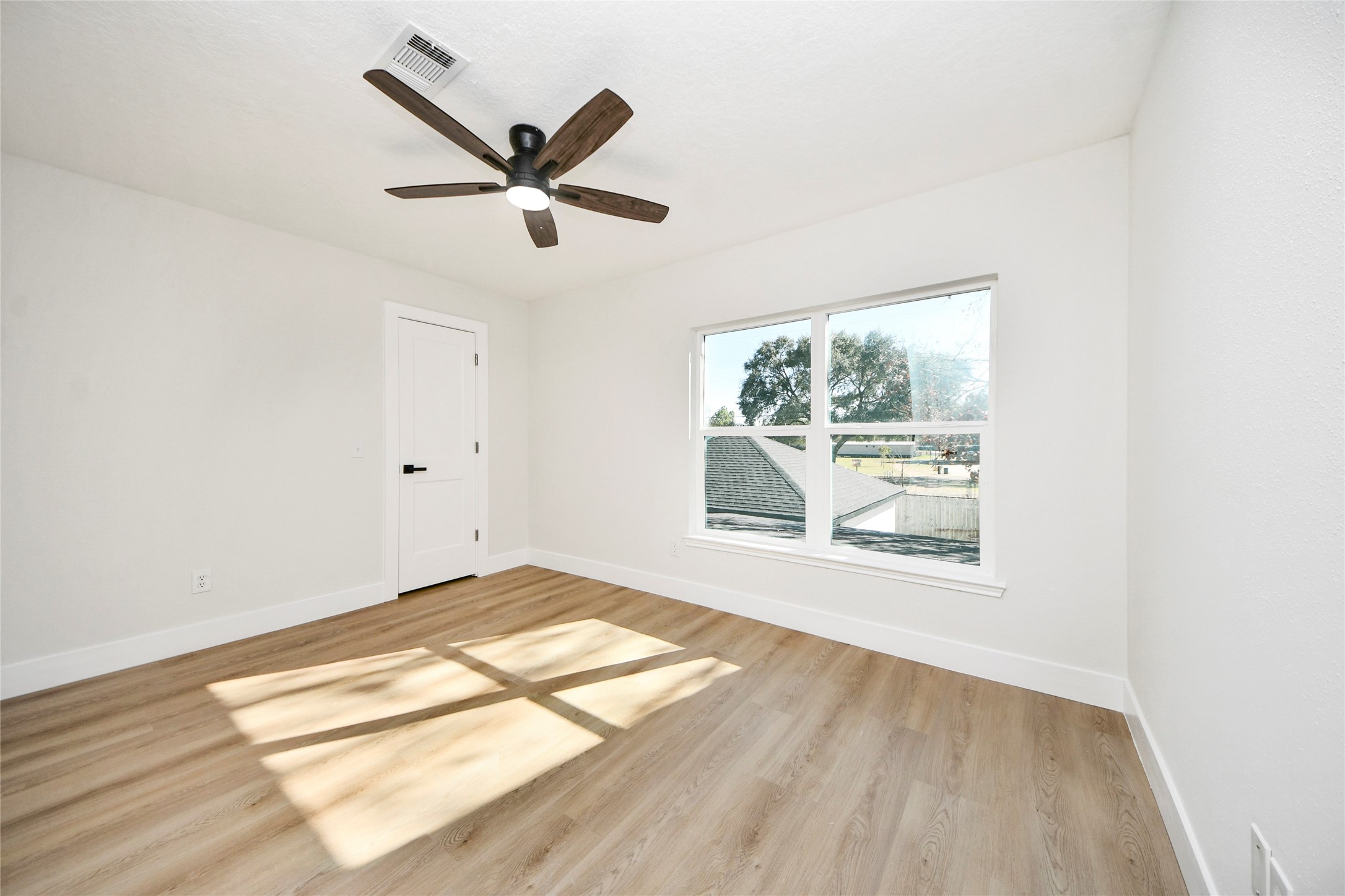10223 Dude Road Houston, TX 77064 - Photo 31 of 44 a view of empty room with wooden floor and fan