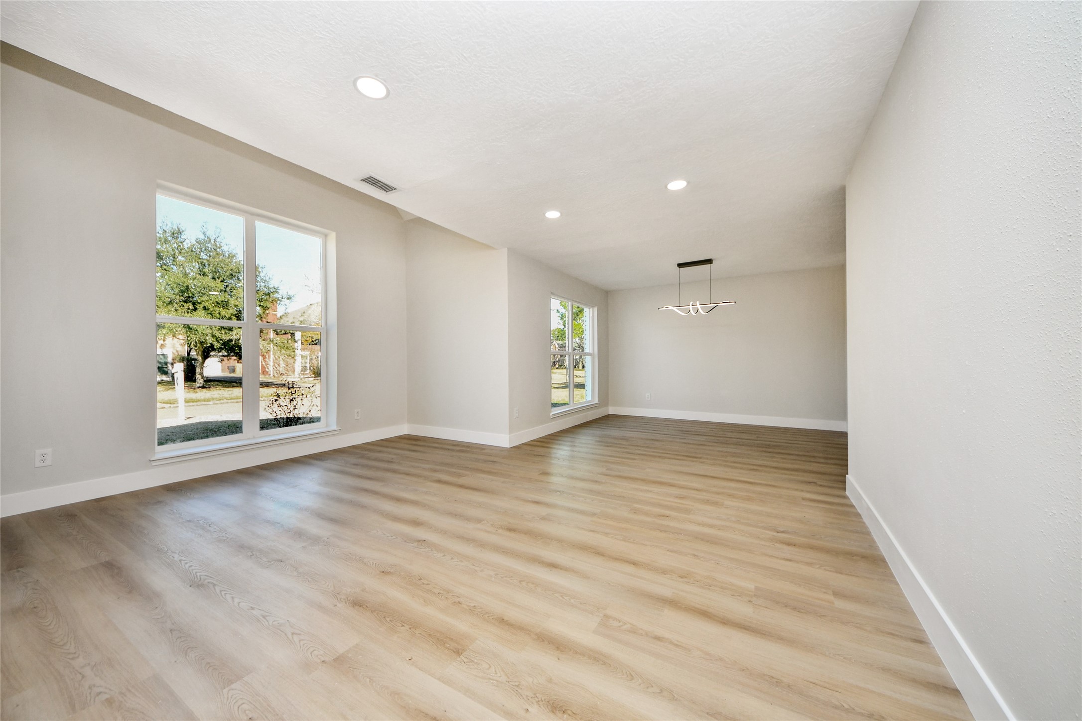 10223 Dude Road Houston, TX 77064 - Photo 5 of 44 an empty room with wooden floor and windows