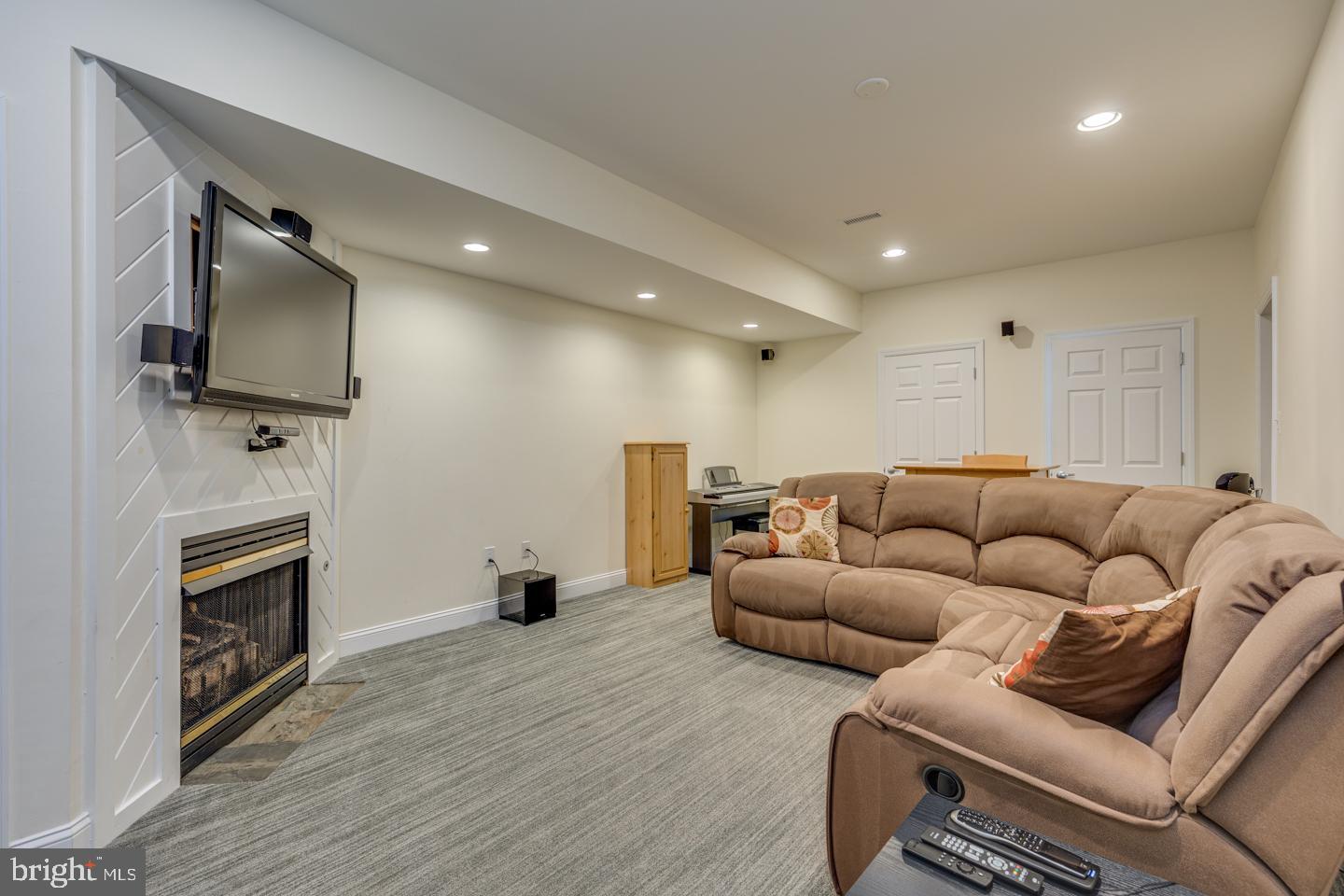 7 Castle Road Shamong, NJ 08088 - Photo 39 of 52 Movie room area with fireplace in basement