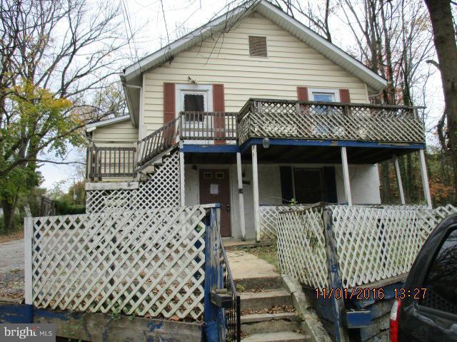 5218 Dogwood Road Gwynn Oak, MD 21207 - Photo 1 of 11 a front view of a house with a deck