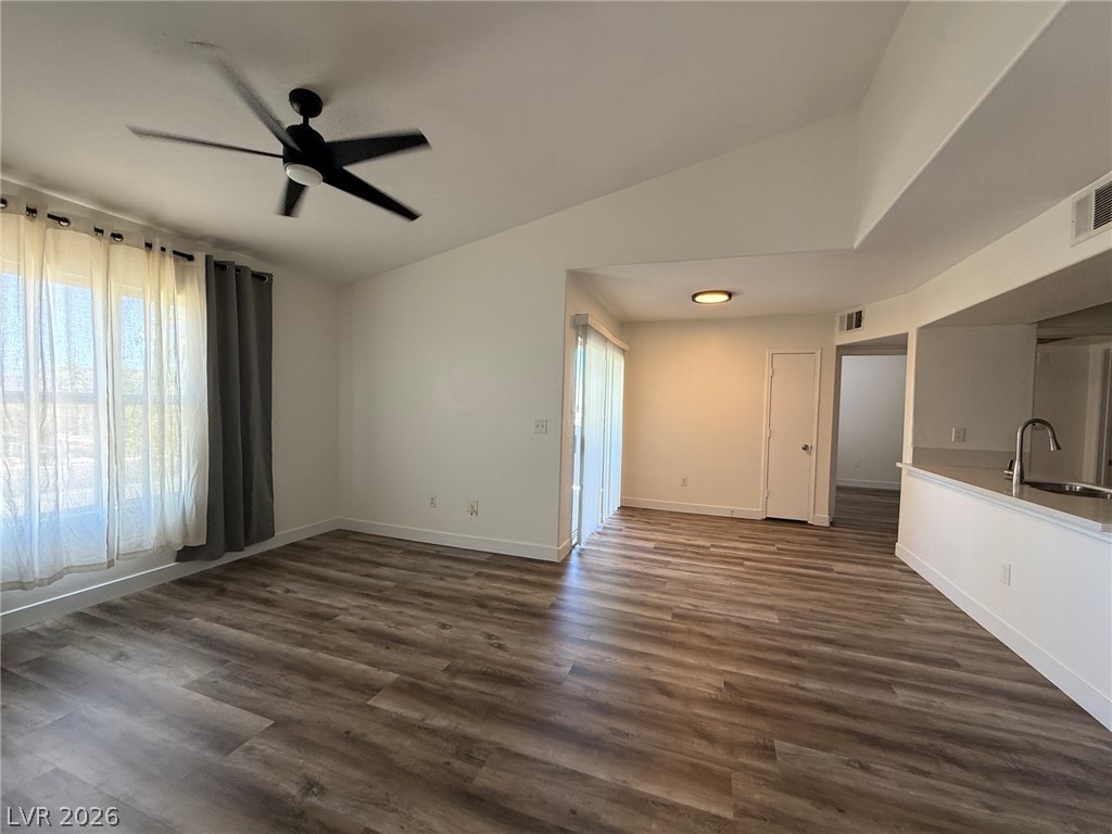 7255 West Sunset Road, Unit 2149 Las Vegas, NV 89113 - Photo 4 of 28 Sun-filled living area features rich wood-look flooring and an overhead ceiling fan.